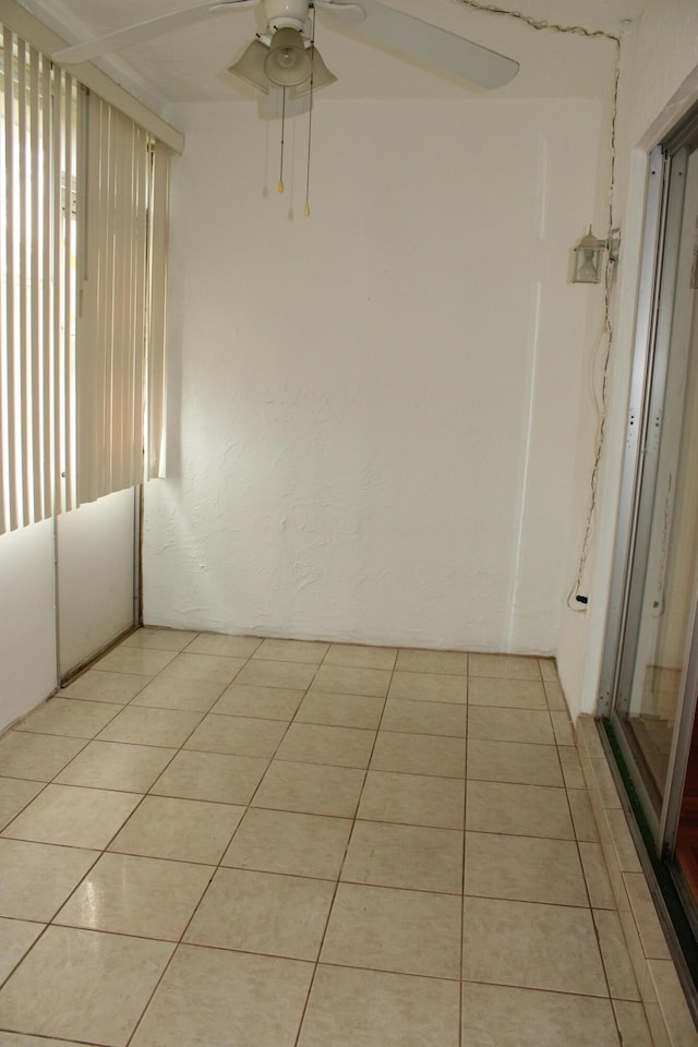 unfurnished room featuring ceiling fan and light tile patterned floors