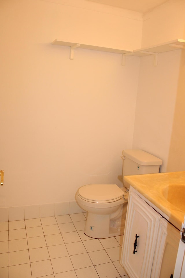 bathroom with tile patterned flooring, vanity, and toilet