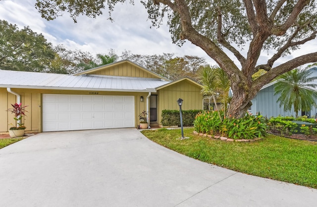 ranch-style home featuring a garage and a front yard