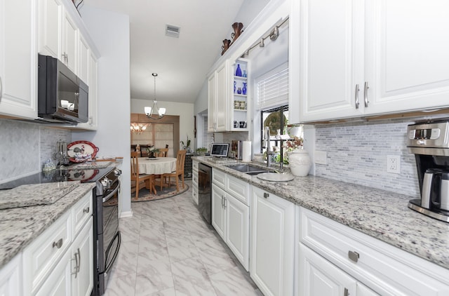 kitchen featuring sink, white cabinets, and black appliances