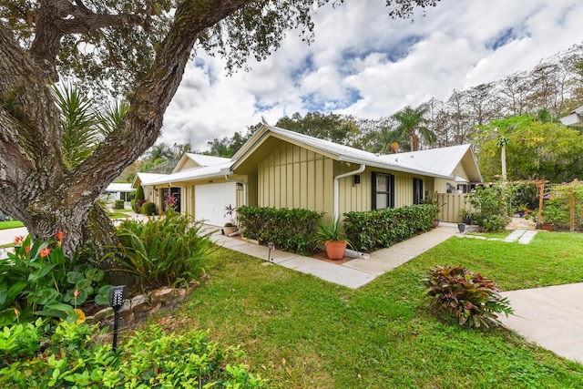 view of front of home featuring a garage and a front lawn