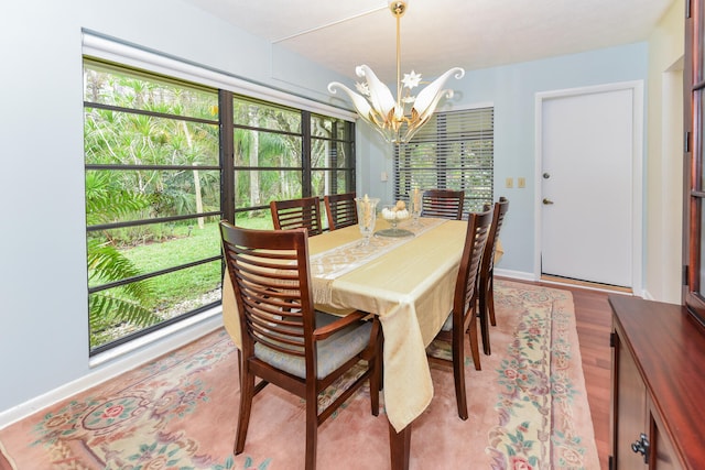 dining space featuring a notable chandelier and light hardwood / wood-style flooring