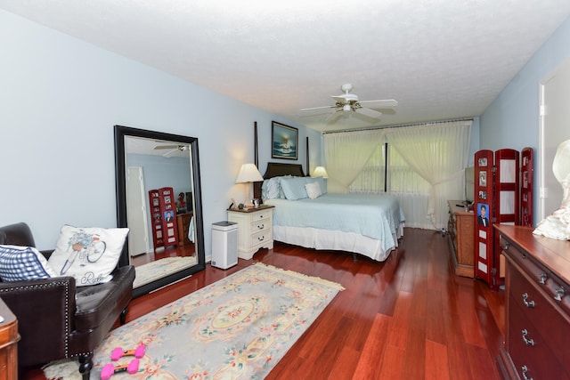 bedroom with ceiling fan and dark wood-type flooring