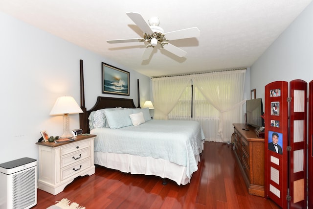 bedroom with ceiling fan and dark hardwood / wood-style flooring