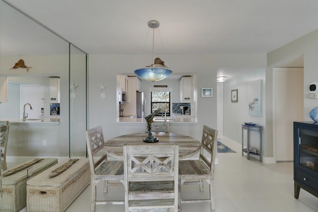 tiled dining space featuring sink