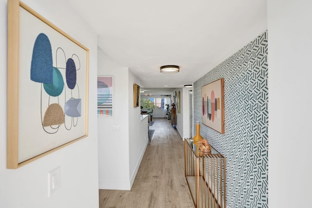 hallway with light hardwood / wood-style floors