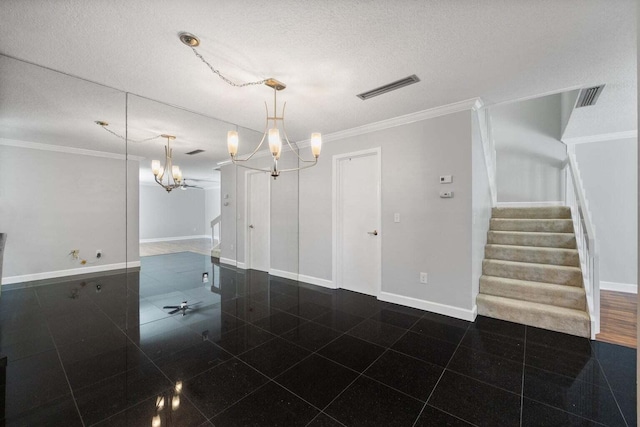 empty room featuring crown molding, a textured ceiling, and a chandelier