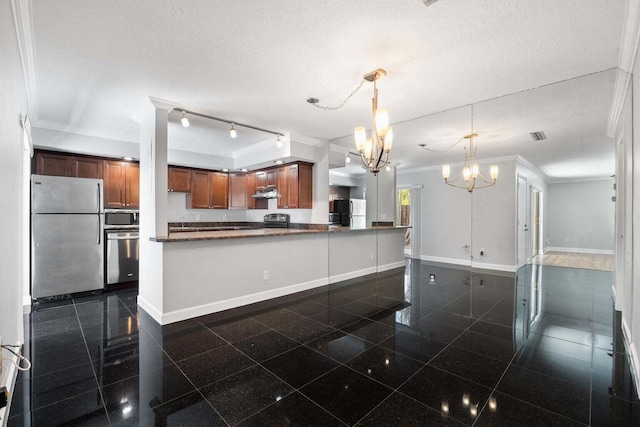 kitchen with appliances with stainless steel finishes, a textured ceiling, and crown molding