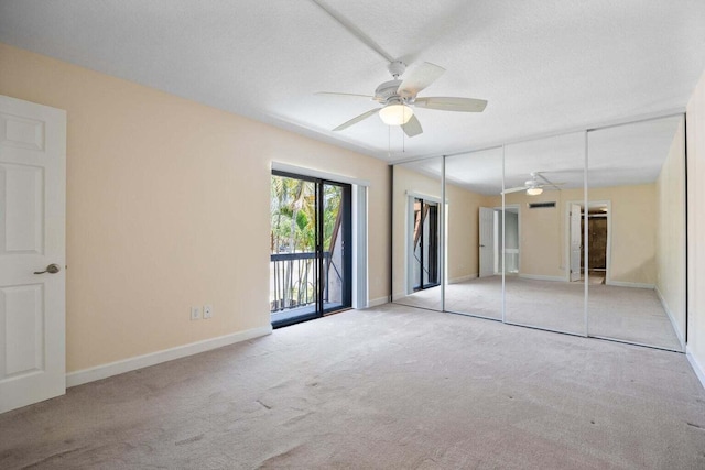 unfurnished bedroom with light carpet, ceiling fan, access to exterior, a textured ceiling, and a closet