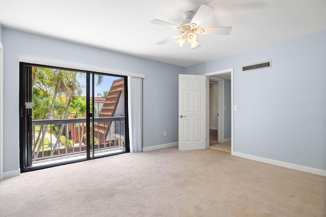 carpeted spare room with ceiling fan