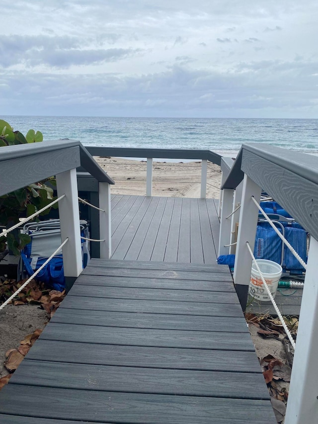 deck featuring a water view and a view of the beach