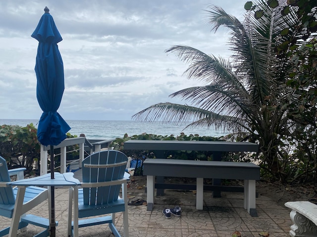 view of patio with a water view