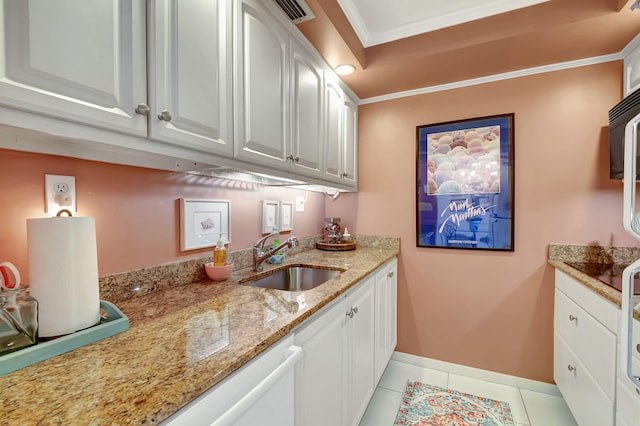 kitchen featuring light stone counters, ornamental molding, sink, white cabinetry, and light tile patterned flooring