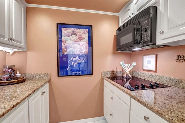 kitchen featuring black appliances, light stone counters, white cabinetry, and ornamental molding