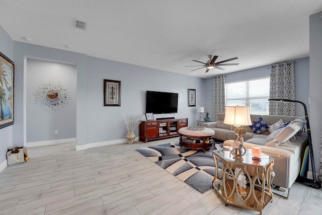 living room featuring light hardwood / wood-style floors and ceiling fan