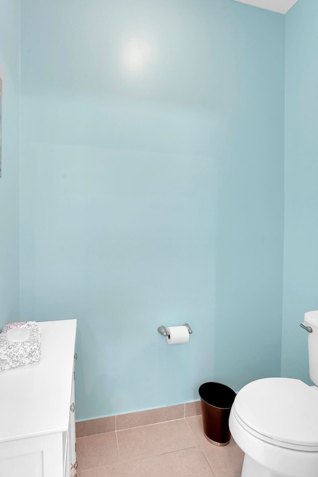 bathroom featuring tile patterned flooring, vanity, and toilet