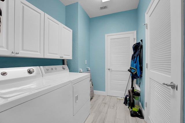 laundry room featuring cabinets and independent washer and dryer