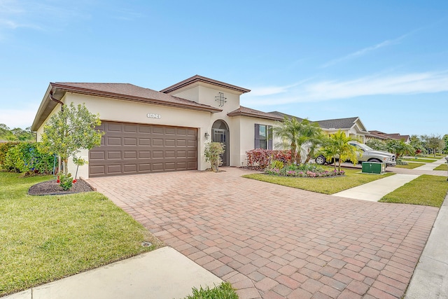 view of front of property with a garage and a front lawn