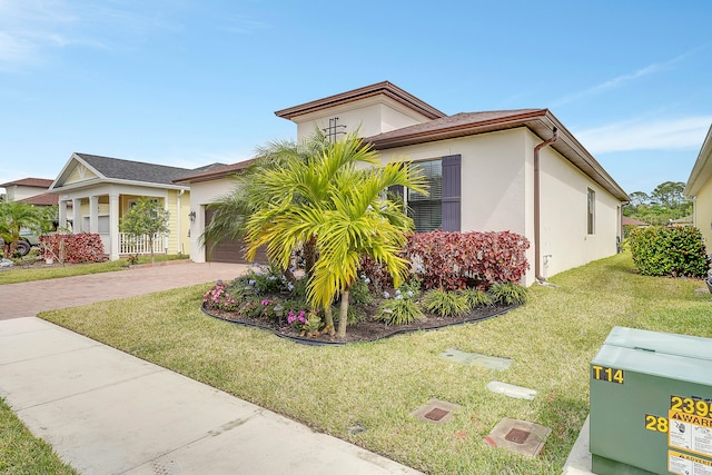 view of front of house with a front yard and a garage