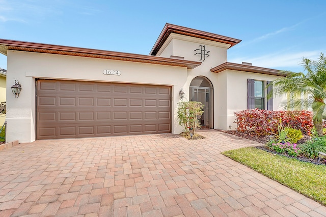 mediterranean / spanish house with a garage