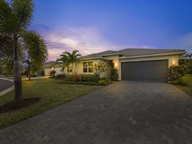 view of front of house with a lawn and a garage