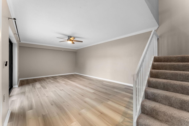 interior space featuring hardwood / wood-style flooring, ceiling fan, and crown molding