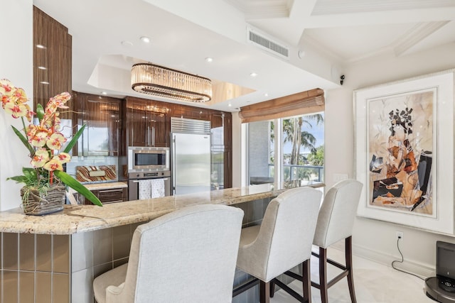 dining area with an inviting chandelier and ornamental molding