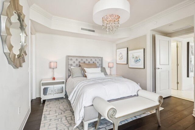 bedroom with hardwood / wood-style flooring, ornamental molding, and a chandelier