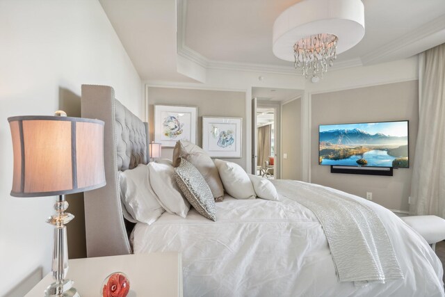 bedroom with an inviting chandelier, wood-type flooring, ornamental molding, and multiple windows