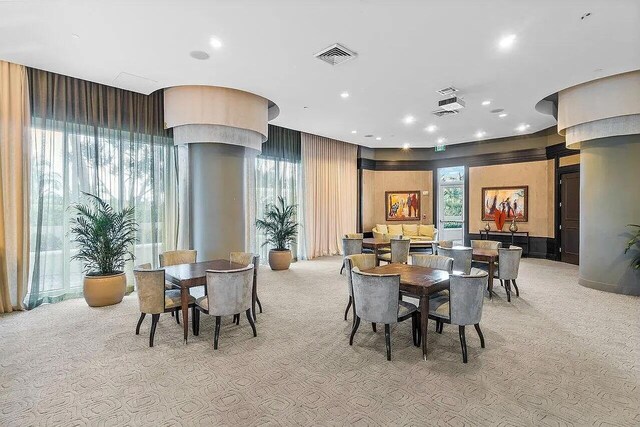 bar featuring light carpet and decorative light fixtures