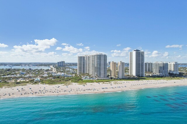 view of building exterior featuring a view of the beach and a water view