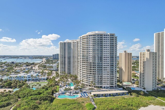 birds eye view of property with a water view and a beach view