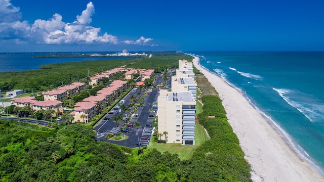 birds eye view of property featuring a water view and a beach view