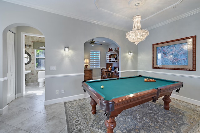 rec room with crown molding, light tile patterned floors, ceiling fan with notable chandelier, and billiards