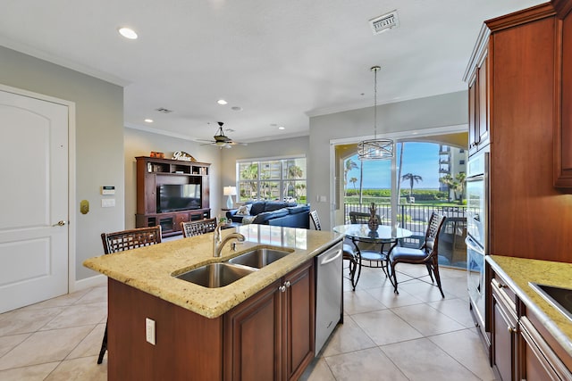 kitchen with ceiling fan with notable chandelier, sink, decorative light fixtures, dishwasher, and an island with sink