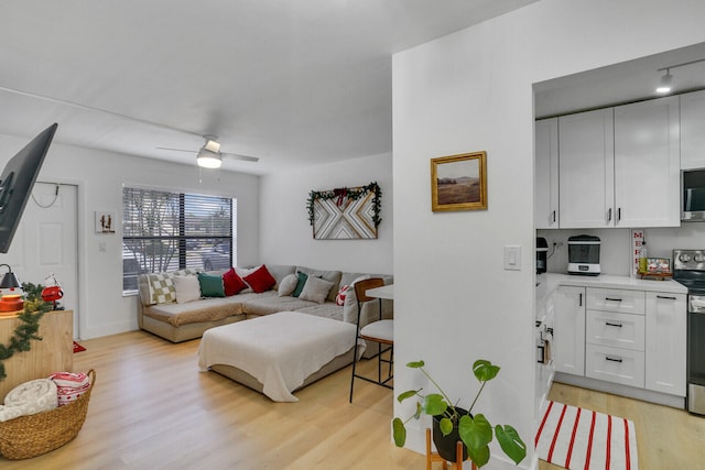 living room featuring ceiling fan and light wood-type flooring