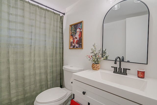 bathroom with a shower with curtain, vanity, and toilet