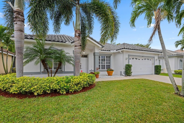 view of front of property with a front lawn and a garage