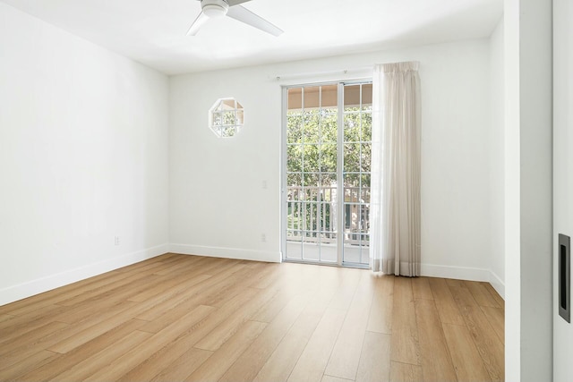 empty room with ceiling fan and light hardwood / wood-style flooring