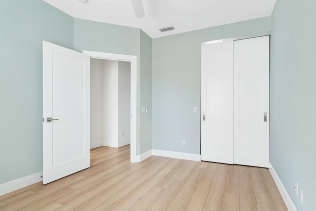 unfurnished bedroom featuring a closet, light hardwood / wood-style flooring, and ceiling fan