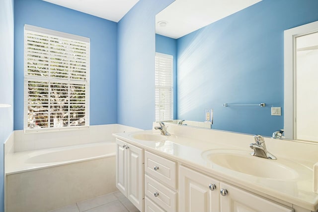 bathroom with a bathing tub, tile patterned flooring, and vanity