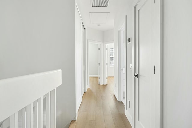 corridor with light hardwood / wood-style flooring