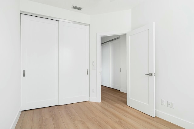 unfurnished bedroom featuring light wood-type flooring