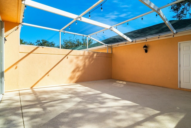 view of patio featuring a lanai