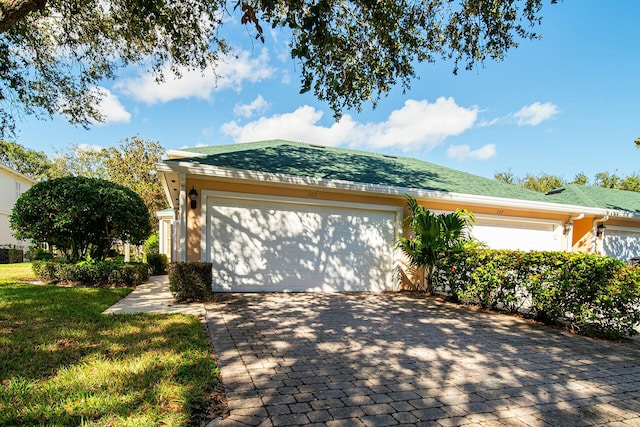 exterior space with a garage and a front yard