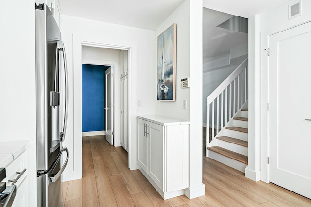 hallway with light hardwood / wood-style floors