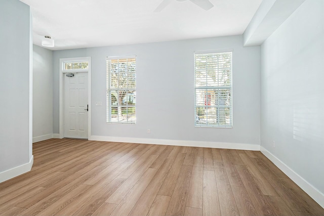 empty room with ceiling fan and light hardwood / wood-style floors