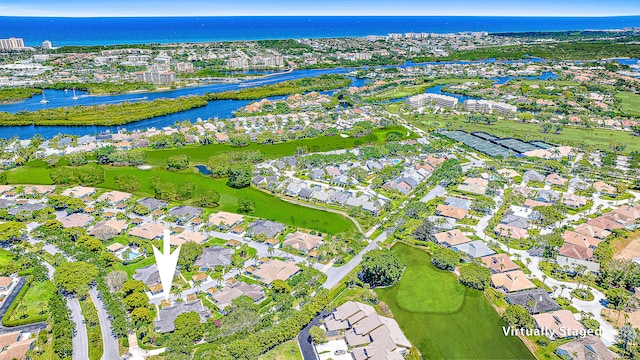 drone / aerial view featuring a residential view and a water view