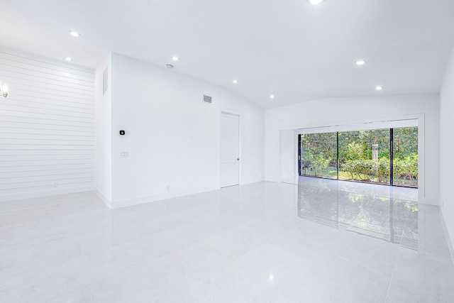 empty room with lofted ceiling