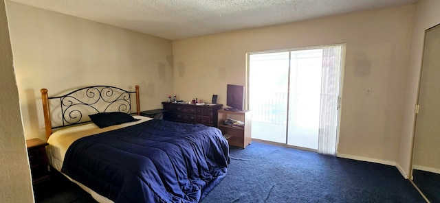 bedroom with a textured ceiling and carpet floors